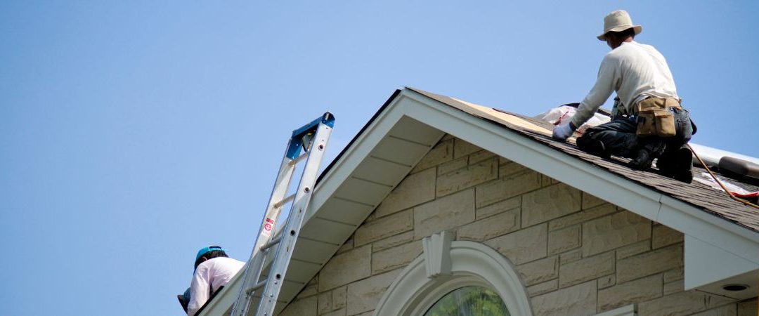 Roofers performing roof maintenance