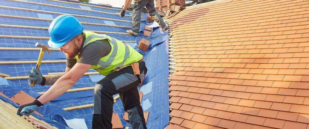 Roofers installing new roof tiles