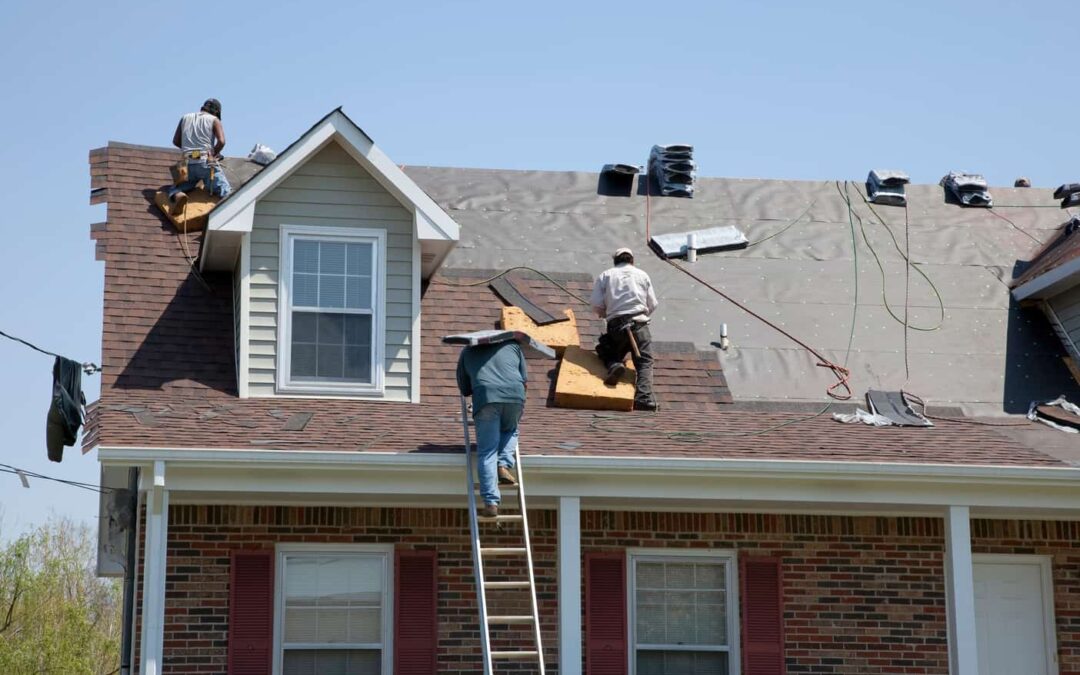 Roofers replacing damaged shingles.