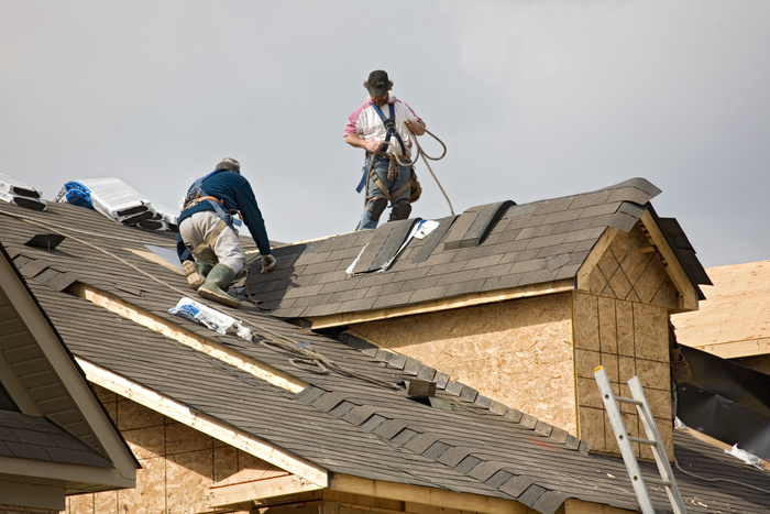 roofing experts re-roofing a house