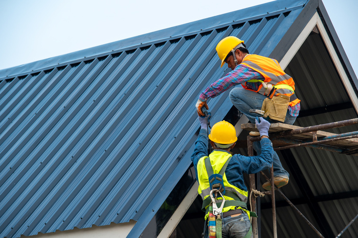 Metal roofing contractors at work